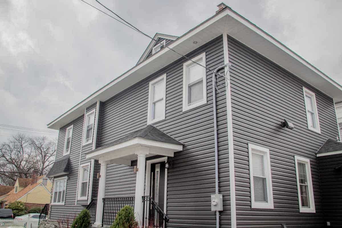 example New Jersey siding contractor which shows beautiful blue/grey siding on a two story home