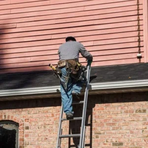 Roofer performing roof inspection in New Jersey